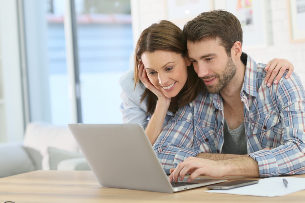 Couple at home websurfing on internet