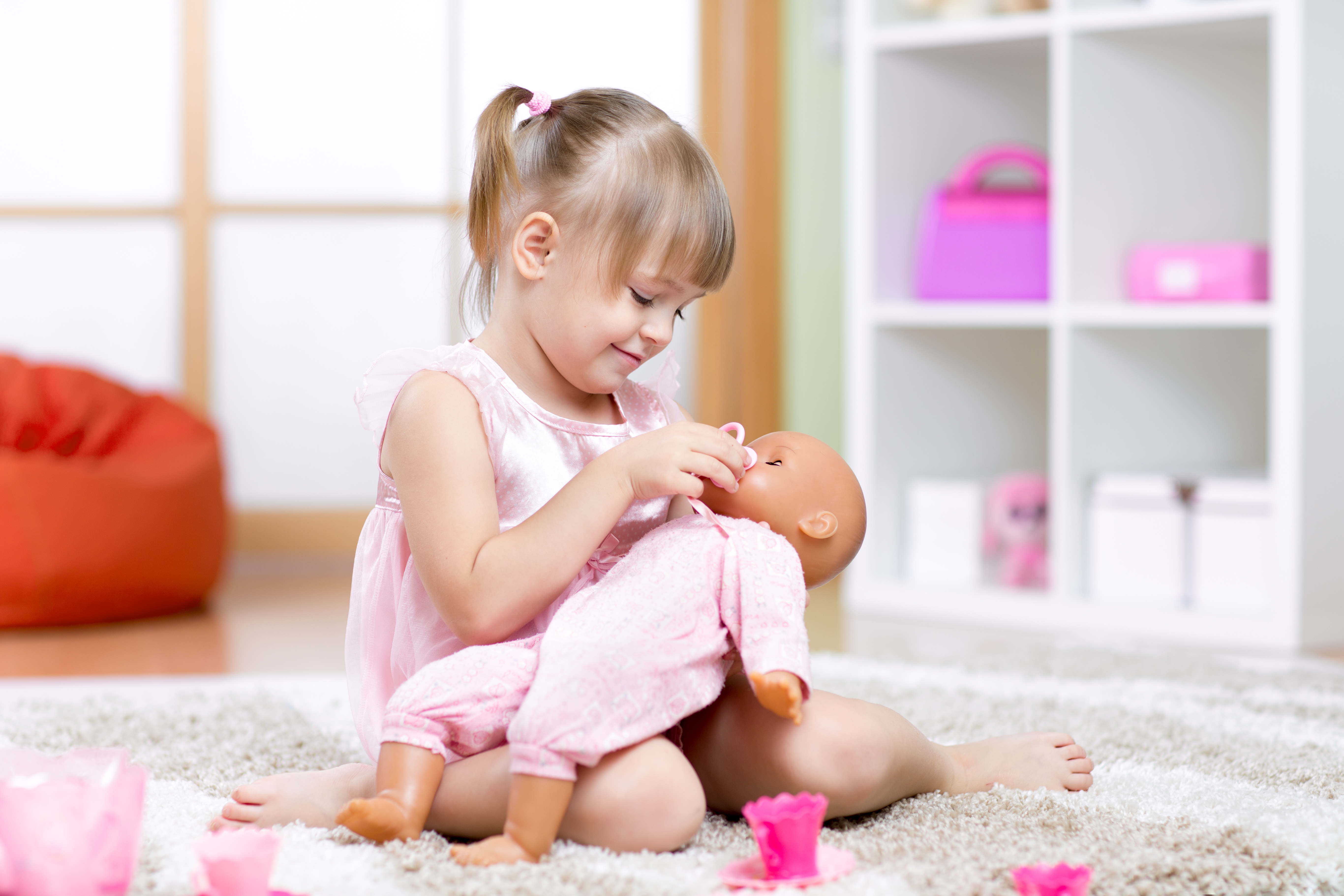 girl playing with her baby-doll